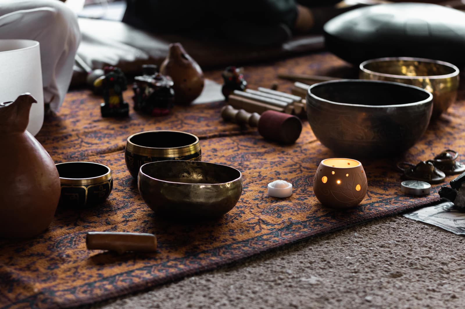 Singing bowls and a candle on the floor of the Atlantis shop